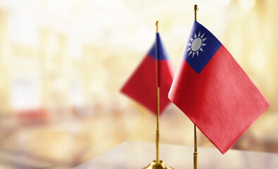 Small flags of the Taiwan on an abstract blurry background