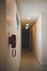 corridor for room in interior of modern apartments, office or clinic with red telephone for emergency. Safety and emergency in corridor apartment. red telephone located in clear and visible area.