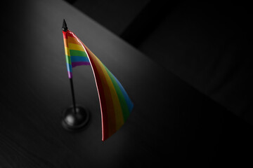 Small national flag of the lgbt on a black background