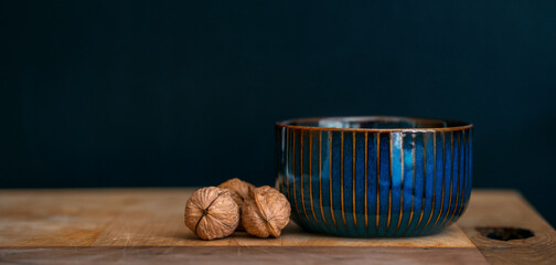 Fototapeta na wymiar Nuts and pot with black background