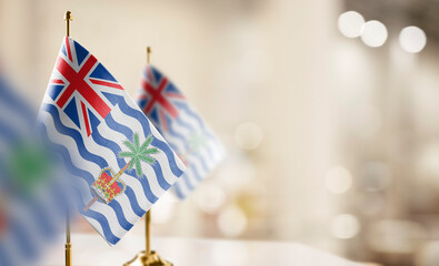 Small flags of the British Indian Ocean Territory on an abstract blurry background