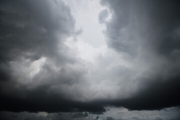 Storm clouds floating in a rainy day with natural light. Cloudscape scenery, overcast weather above blue sky. White and grey clouds scenic nature environment background