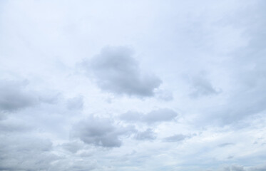 Storm clouds floating in a rainy day with natural light. Cloudscape scenery, overcast weather above blue sky. White and grey clouds scenic nature environment background