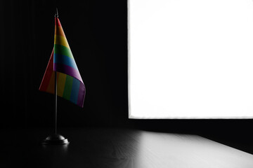 Small national flag of the lgbt on a black background