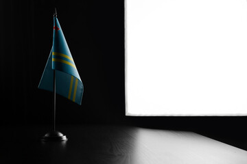 Small national flag of the Aruba on a black background