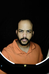 Bearded adult man portrait with ring light and black backdrop