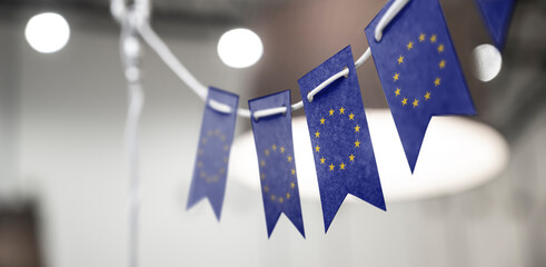 A garland of European Union national flags on an abstract blurred background