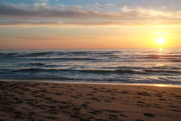 Beautiful sunset at the beach in portugal at the atlantic ocean close to lissabon. Wallpaper surf
