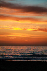 Beautiful sunset at the beach in portugal at the atlantic ocean close to lissabon. Wallpaper surf