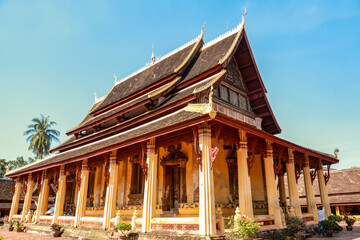 Naklejka premium Beautiful buddha temple in Asia (Thailand, Laos). Golden pagoda, stupa. Wallpaper