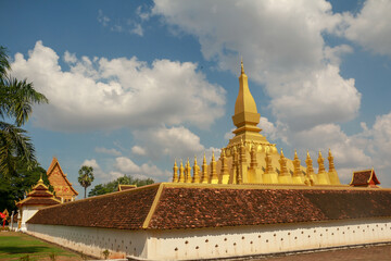 Naklejka premium Wallpaper of Vientiane the golden city with sleeping buddha statue and golden temple. Popular for the giant gate. Asia