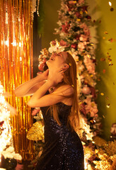 Happiness and fun partying emotions during night party. Falling confetti while girl in pink glasses with blurred lights on background. High quality vertical image