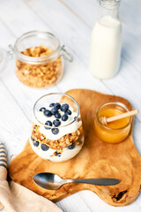 Homemade granola with nuts and fresh blueberries for breakfast. Healthy breakfast. Vegetarian food concept