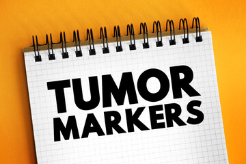 Tumor markers - biomarker found in blood, urine, or body tissues that can be elevated by the presence of one or more types of cancer, medical text concept on notepad