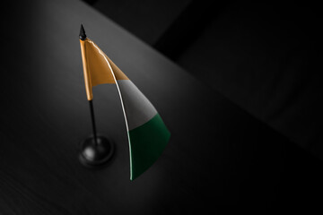 Small national flag of the Cote dIvoire on a black background