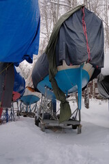 Yacht, boat, ship on the shore under a canopy awning in the snow