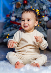 Christmas portrait of cute little baby boy. Lovely baby boy enjoy christmas. Little child celebrate christmas at home.