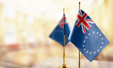 Small flags of the Cook Islands on an abstract blurry background