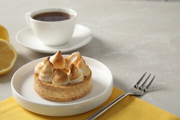 Delicious lemon meringue pie served on white table