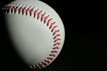 Baseball ball on black background, closeup with space for text. Sports game
