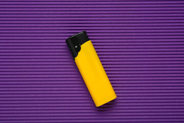 Stylish small pocket lighter on purple corrugated fiberboard, top view
