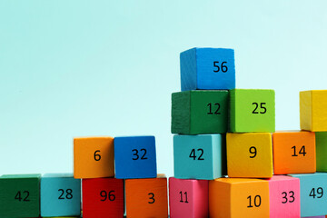 Wooden cubes with different numbers on light background