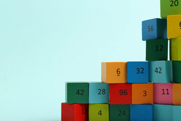 Wooden cubes with different numbers on light background. Space for text