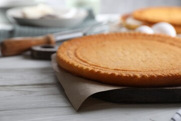 Delicious homemade sponge cake on white wooden table, closeup