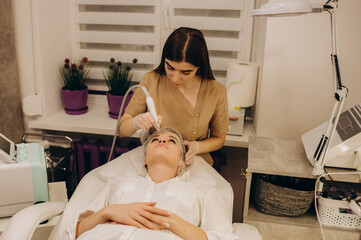 Close-up of woman getting facial hydro microdermabrasion peeling treatment.
