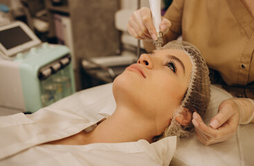Close-up of woman getting facial hydro microdermabrasion peeling treatment.