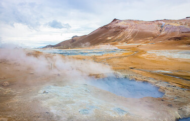 Hverir , Iceland geothermal area at the Namafjall volcanic mountain. Hverir is also known as Namafjall or Namaskard. Surreal nature landscape, selective focus on mud pool. 