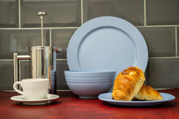 expresso coffee cup and saucer stainless steel cafetiere   with fresh coissant blue dinner set  on...