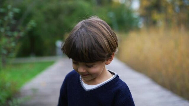 Little boy walking outside in nature. Handsome child enjoying park outdoors during weekend family activity