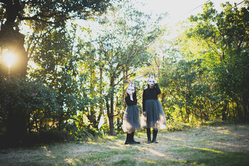 girls with rabbit masks standing in the garden