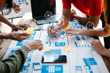  UX developer and ui designer brainstorming about mobile app interface wireframe design with customer breif and color code at office.