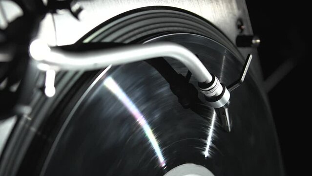 Vinyl record player spinning analog disc. Turntables needle plays music in vertical video clip