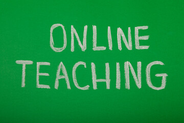 Chalk inscription online teaching on green school board.Learning concept.