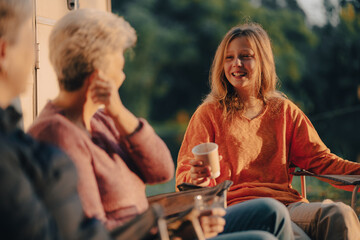female family in holiday with hot drink of coffee or tea, young woman person in vacation tent camping lifestyle with nature to adventure mountain hiking travel, happy together with morning drink