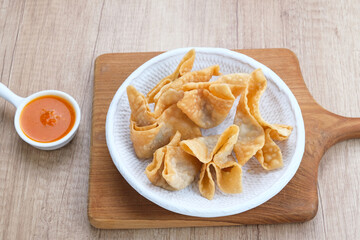 Pangsit Goreng (Chicken Fried Dumpling), Indonesian Traditional Food. Served with sauce
