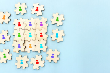 Business image of wooden puzzle with people icons over blue background, human resources and management concept