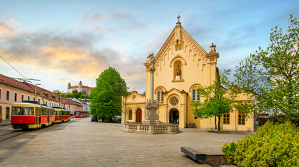 Fototapeta na wymiar Bratislava, Slovakia. Church of St. Stephan of Hungary and the Bratislava castle at sunset
