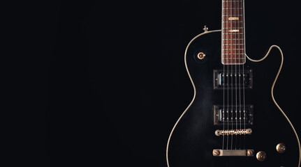 Naklejka na ściany i meble Guitar body on black background
