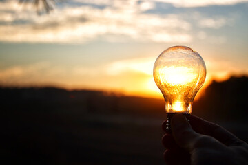 energy and business concept image. Creative idea and innovation. light bulb metaphor in front of...