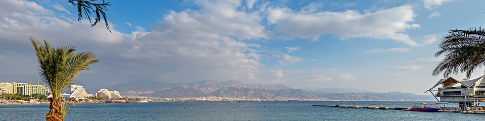 Panorama of central public beach in Eilat - famous tourist resort and recreational city located on the Red Sea, Israel

