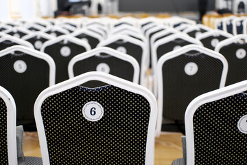 Empty rows of vintage black velvet chairs in concert hall. Auditorium, black old chairs background.