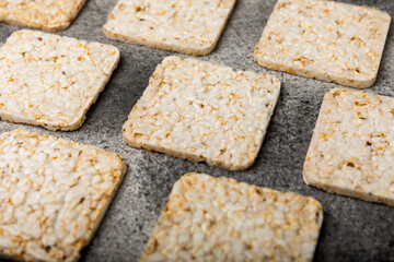 puffed rice bread on black texture background. Healthy crunchy snack. Whole grain crispy bread. Healthy food. Diet. Copy space. Place for text.