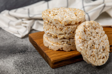 puffed rice bread on black texture background. Healthy crunchy snack. Whole grain crispy bread. Healthy food. Diet. Copy space. Place for text.
