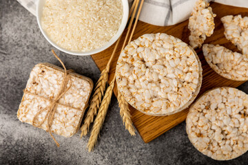 puffed rice bread on black texture background. Healthy crunchy snack. Whole grain crispy bread. Healthy food. Diet. Copy space. Place for text.