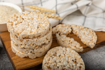 puffed rice bread on black texture background. Healthy crunchy snack. Whole grain crispy bread. Healthy food. Diet. Copy space. Place for text.