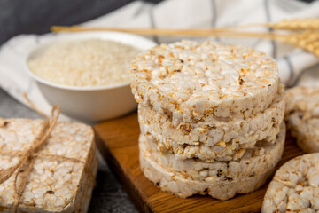 puffed rice bread on black texture background. Healthy crunchy snack. Whole grain crispy bread. Healthy food. Diet. Copy space. Place for text.